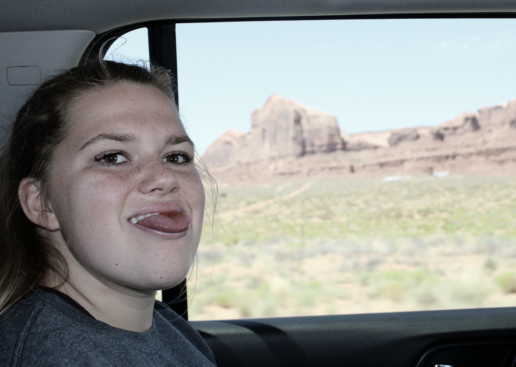 daughter sticking her tongue out while traveling
