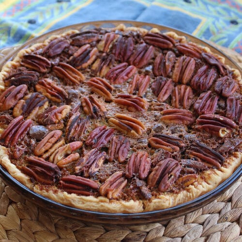 beautiful baked chocolate orange pecan pie in a glass pie plate
