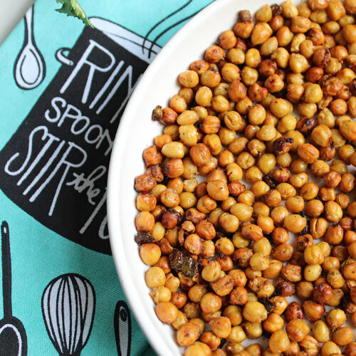 crunchy roasted chickpeas with jalapenos in a white bowl on a turquoise blue dish towel