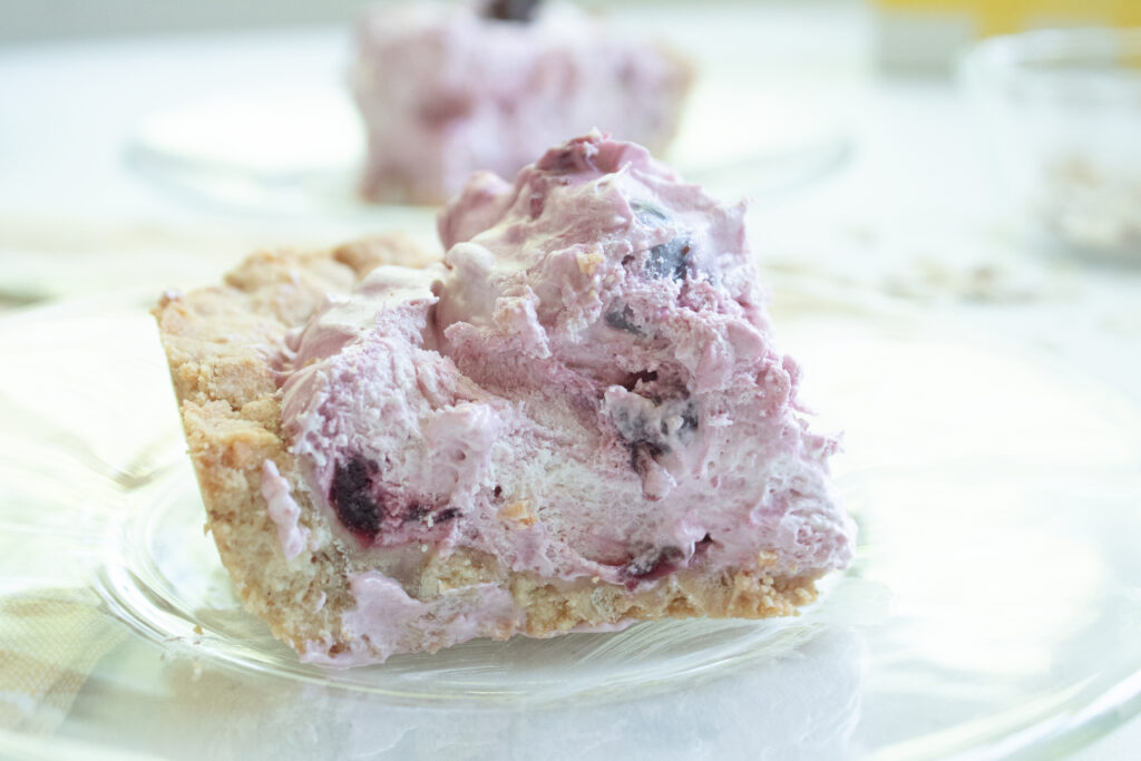 close up of one piece of the cherry shortbread fluff bars