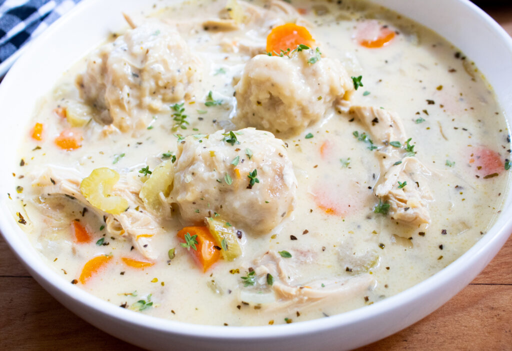 close up of easy chicken and dumplings recipe in a white bowl