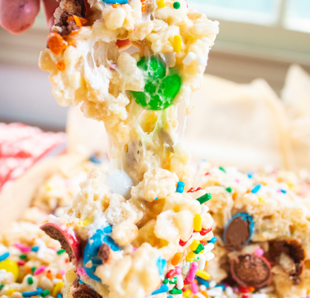 up close of a pull apart gooey rice krispie treat with M&Ms