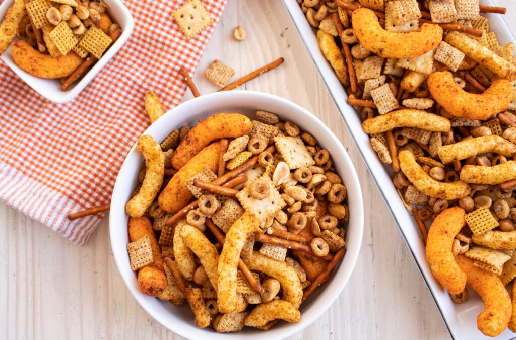 chex mix with cheetos in 3 sizes of serving bowls
