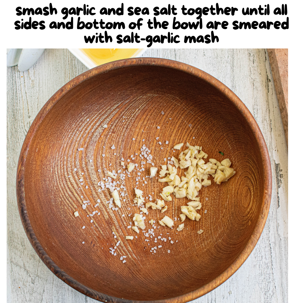 step one with smashed garlic, coarse sea salt in a wooden bowl.