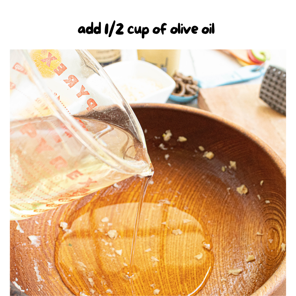 step 3 - olive oil added to wooden bowl and swirled around all inside.