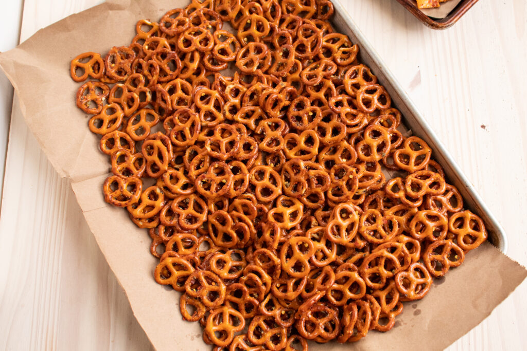 Marinated Italian pretzels drying on a large cut brown paper bag on a large baking sheet.