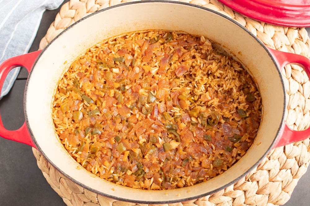 Easy Mexican Baked Rice right out of the oven in a red dutch oven.