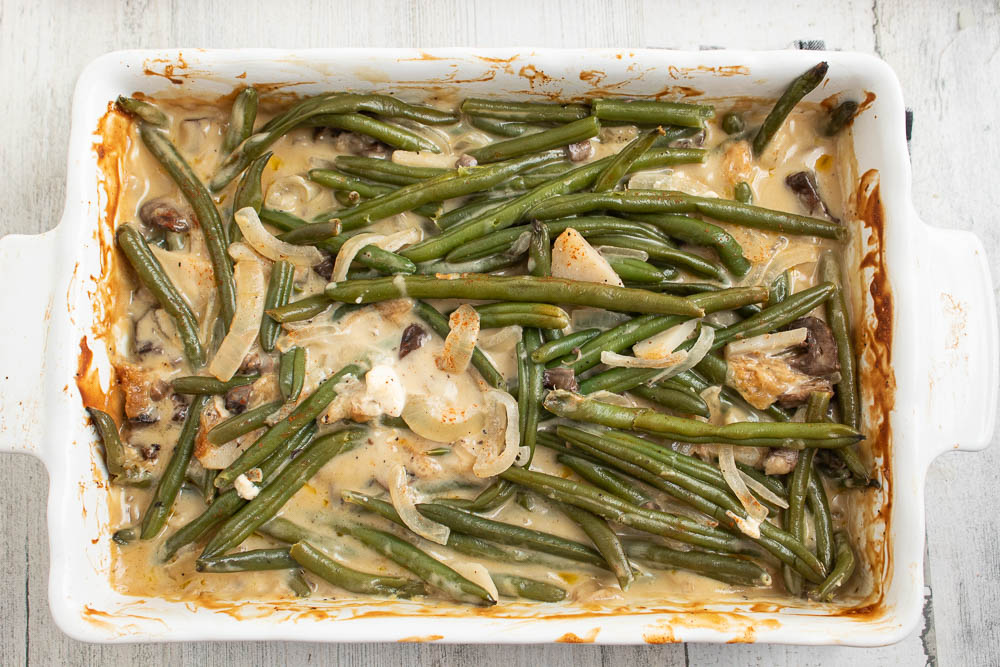 Cooked green bean casserole in a white rectangle casserole dish.