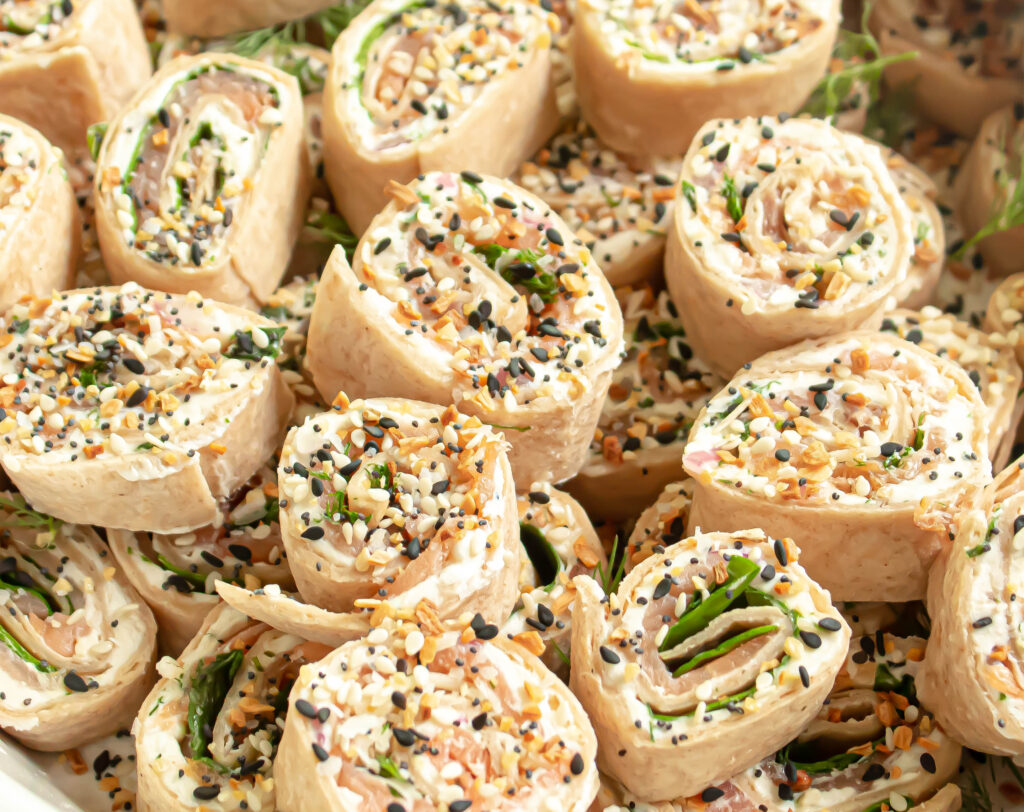 Close up of finished salmon pinwheels with everything cream cheese on a plate.
