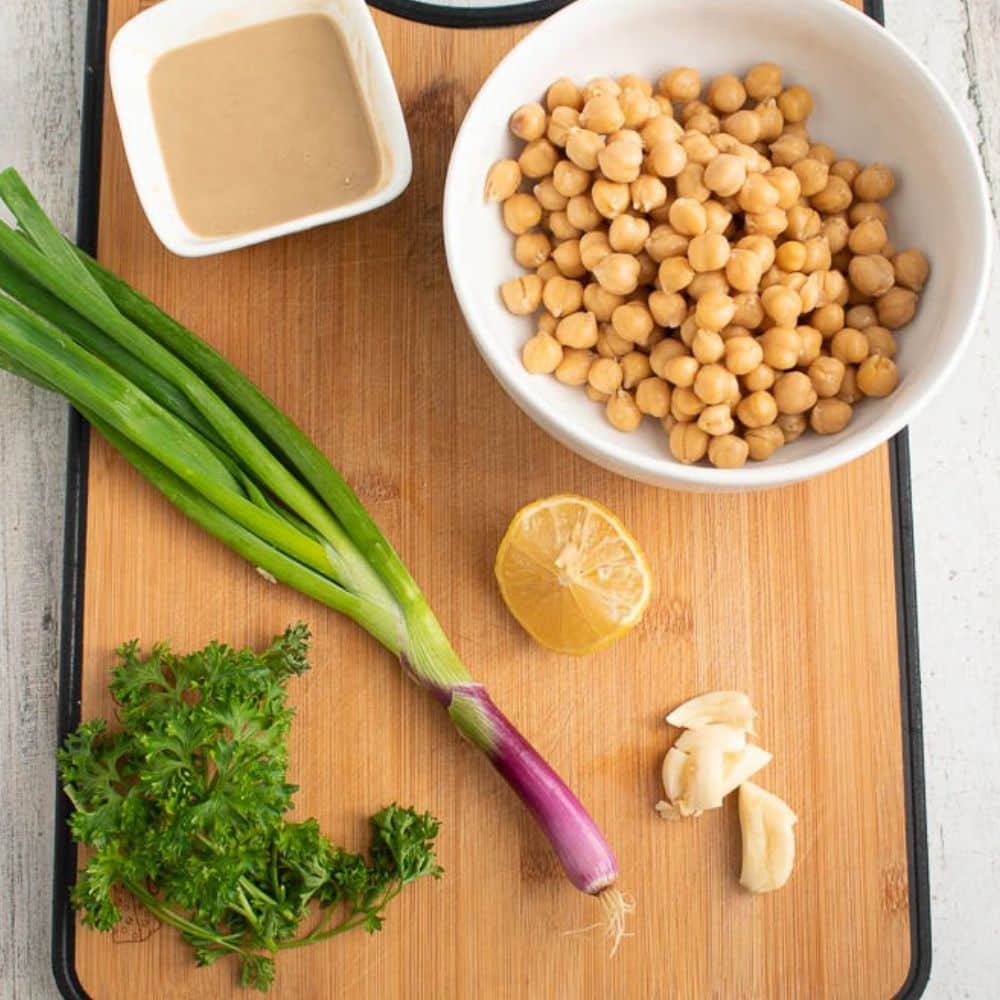 Basic Homemade Hummus Recipe ingredients on a cutting board.